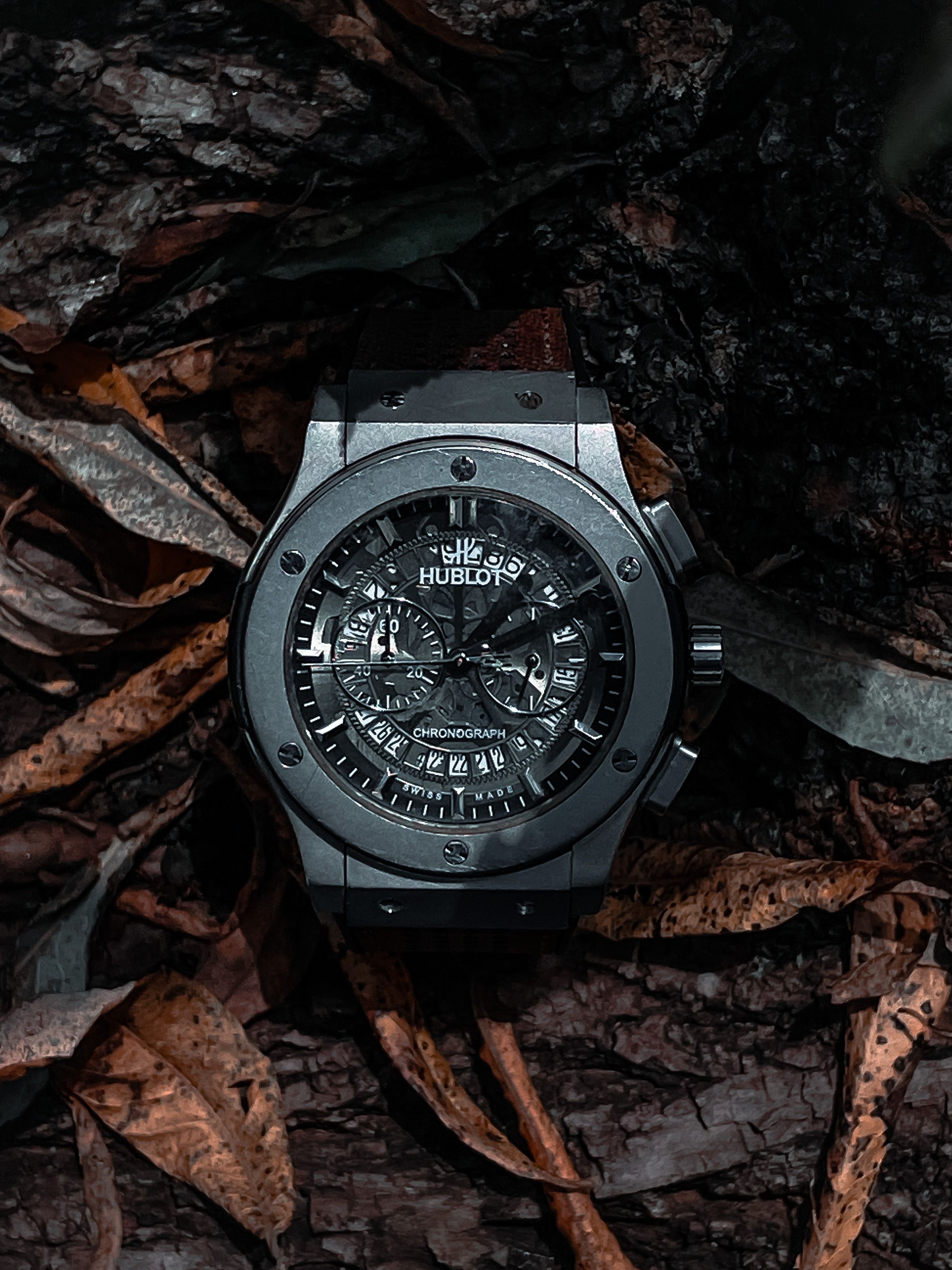 Hublot watch photographed on a dark background, showcasing the bezel and chronograph dial